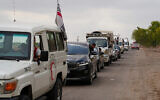 Syrian Bedouin families ride in a convoy led by Red Crescent vehicles in Busra al-Harir, heading to Daraa after being evacuated from Sweida following more than a week of violent clashes, July 21, 2025. (Malek Khattab/AP)