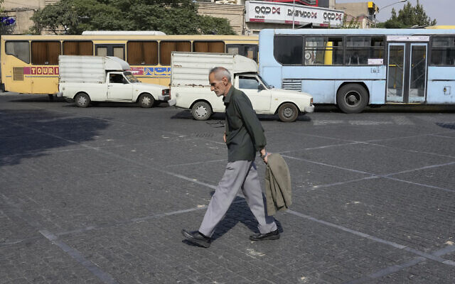 A man crosses an intersection on a hot summer day in downtown Tehran, Iran, July 21, 2025. (AP Photo/Vahid Salemi)