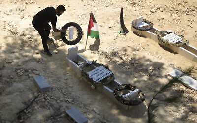 A man tidies the graves of Palestinian-American Sayfollah Musallet, left, and Mohammed al-Shalabi, both of whom were allegedly killed by settlers in the West Bank town of Al-Mazra’a Al-Sharqiya, July 21, 2025. (AP Photo/Maya Alleruzzo) A man tidies the graves of Palestinian-American Sayfollah Musallet, left, and Mohammed al-Shalabi, both of whom were allegedly killed by settlers in the West Bank town of Al-Mazra’a Al-Sharqiya, July 21, 2025. (AP Photo/Maya Alleruzzo)