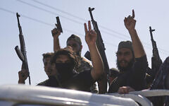 Bedouin fighters stand on a pickup truck as they arrive at al-Dour village on the outskirts of Sweida city, during clashes between the Bedouin clans and Druze militias, southern Syria, July 18, 2025. (AP Photo/Ghaith Alsayed)