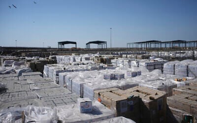 Piles of humanitarian aid packages wait to be picked up on the Palestinian side of the Kerem Shalom crossing in the Gaza Strip, Thursday, July 24, 2025. during a media tour organized by the Israeli army. (AP Photo/Ohad Zwigenberg)