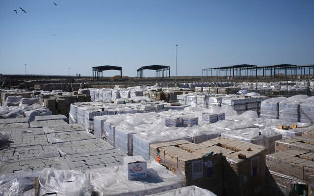 Piles of humanitarian aid packages wait to be picked up on the Palestinian side of the Kerem Shalom crossing in the Gaza Strip, Thursday, July 24, 2025. during a media tour organized by the Israeli army. (AP/Ohad Zwigenberg)