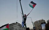 FILE: A protester waves a Palestinian flag during a demonstration against the war in the Gaza Strip outside Greece's Parliament in central Athens, Thursday, July 24, 2025. (AP/Petros Giannakouris)
