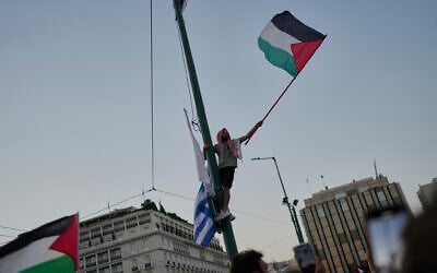 FILE: A protester waves a Palestinian flag during a demonstration against the war in the Gaza Strip outside Greece's Parliament in central Athens, Thursday, July 24, 2025. (AP/Petros Giannakouris)