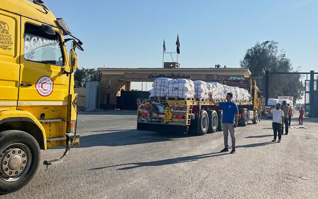 Trucks carrying humanitarian aid enter the Rafah crossing between Egypt and the Gaza Strip, July 27, 2025. (AP/ Mohamed Arafat)