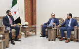 Syria's interim President Ahmad al-Sharaa, left, meets with Syria's Foreign Minister Asaad al-Shibani, center, and Mohammed Taha al-Ahmad, chairman of the Higher Committee for People's Assembly Elections, right, in Damascus, Syria, July 27, 2025. (Syria's official news agency, SANA via AP)