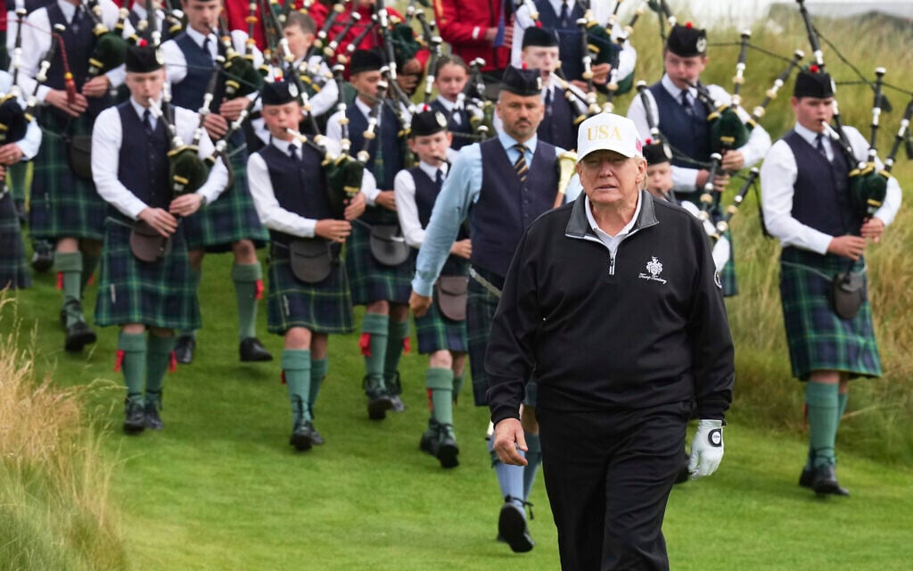 President Donald Trump arrives, followed by a bagpiper band, at the opening ceremony for the Trump International Golf Links golf course, near Aberdeen, Scotland, Tuesday, July 29, 2025. (AP/Jacquelyn Martin)