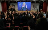 People raise their fists as Hezbollah leader Naim Qassem delivers a televised speech in Dahiyeh, a southern suburb of Beirut, Lebanon, July 30, 2025, during a commemoration marking the first anniversary of the death of top Hezbollah commander Fuad Shukr, who was killed in an Israeli airstrike. (AP Photo/Bilal Hussein)