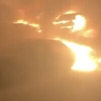 A screenshot of video showing cars that were allegedly set ablaze by Israeli settlers, on the outskirts of the West Bank Palestinian village of Burqa, July 14, 2025. (X Screenshot)