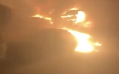 A screenshot of video showing cars that were allegedly set ablaze by Israeli settlers, on the outskirts of the West Bank Palestinian village of Burqa, July 14, 2025. (X Screenshot)