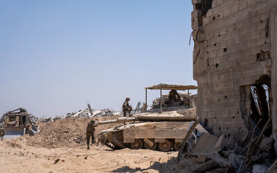 IDF troops are seen in on a tank on the outskirts of Gaza City's Daraj and Tuffah neighborhoods, July 23, 2025. (Emanuel Fabian/Times of Israel)