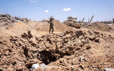 IDF troops of the Givati Brigade stand over a tunnel shaft in northern Gaza's Beit Hanoun, July 30, 2025. (Emanuel Fabian/Times of Israel)