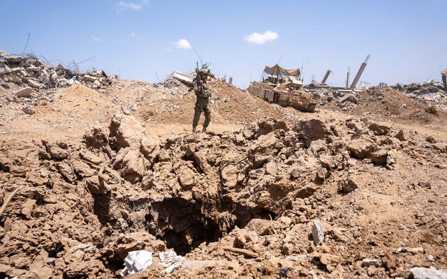 IDF troops of the Givati Brigade stand over a tunnel shaft in northern Gaza's Beit Hanoun, July 30, 2025. (Emanuel Fabian/Times of Israel)