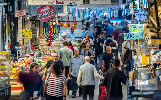 People shop at the Mahane Yehuda Market in Jerusalem, on June 25, 2025, a day after Israel and Iran reached a ceasefire to end 12 days of conflict. (Yonatan Sindel/ Flash90) People shop at the Mahane Yehuda Market in Jerusalem, on June 25, 2025, a day after Israel and Iran reached a ceasefire to end 12 days of conflict. (Yonatan Sindel/ Flash90)