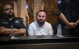 Chaim Rotter, arrested on suspicion of numerous sex offenses, at a court hearing at the Magistrate's Court in Tel Aviv on July 2, 2025 (Avshalom Sassoni/Flash90)