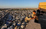 Illustrative: A boy looks over a Palestinian tent city in the al-Mawasi area in Khan Younis, in the southern Gaza Strip, July 6, 2025. (Abed Rahim Khatib/Flash90)