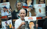 Ex-captive Keith Siegel and families of hostages attend a Foreign Affairs and Defense Committee meeting at the Knesset, July 8, 2025. (Chaim Goldberg/Flash90)