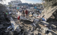Palestinians at the site of an Israeli airstrike at the Al-Shati refugee camp, in the central Gaza Strip, on July 13, 2025. (Ali Hassan/Flash90)