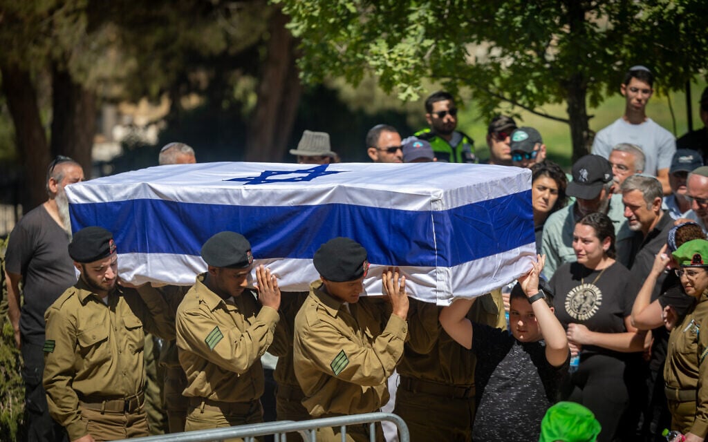 Friends and family attend the funeral of IDF soldier Sgt. Shlomo Yakir Shrem at the military cemetery in Kfar Etzion, July 15, 2025. (Yonatan Sindel/Flash90)