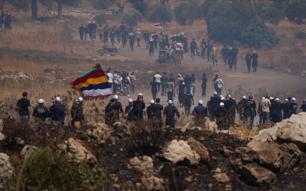 Druze residents protest near the Israeli-Syrian border fence in solidarity with their community in Syria, in Majdal Shams, July 16, 2025. (Michael Giladi/Flash90)