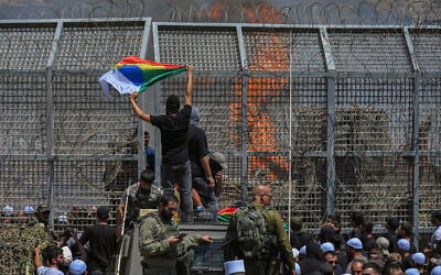 Druze residents protest near the Israeli-Syrian border fence in solidarity with their community in Syria, in Majdal Shams, July 16, 2025. (Michael Giladi/Flash90) Druze residents protest near the Israeli-Syrian border fence in solidarity with their community in Syria, in Majdal Shams, July 16, 2025. (Michael Giladi/Flash90)