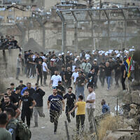 Druze in Israel protest near the Israeli-Syrian border fence in solidarity with Druze in Syria, July 16, 2025. (Michael Giladi/Flash90)