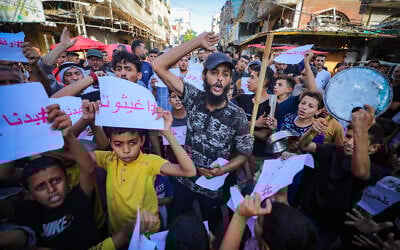 Palestinians gather to demand an end to Israeli attacks and the entry of humanitarian aid on July 20, 2025, in the central Gaza Strip. (Photo by Ali Hassan/Flash90)