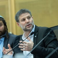 Finance Minister Bezalel Smotrich, right, attends a Knesset conference discussing Jewish settlement in the Gaza Strip at the Knesset in Jerusalem, July 22, 2025. (Chaim Goldberg/Flash90)
