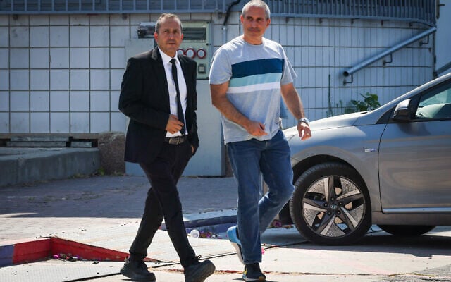 Likud MK Hanoch Milwidsky (right) is seen leaving the Lahav 433 police unit headquarters in Lod on July 25, 2025, alongside his attorney. (Roy Alima/Flash90)