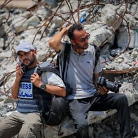 Palestinian journalists report on the war and ongoing humanitarian crisis in the central Gaza Strip, July 26, 2025. (Ali Hassan/ Flash90)