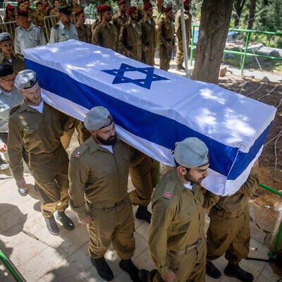 Family and friends attend the funeral of late IDF soldier Bezalel Yehoshua Mosbacher, at the Mount Herzl military cemetery in Jerusalem, July 27, 2025. He died from his wounds after being injured in combat in the southern Gaza Strip. (Chaim Goldberg/Flash90)