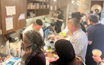 The cholent served on Thursday nights at Hadar Geula in Jerusalem is scooped from giant pots behind a packed counter. (Philissa Cramer/ JTA)