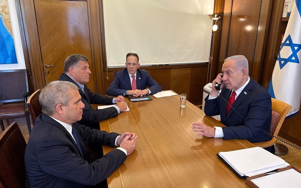 Prime Minister Benjamin Netanyahu, right, meeting with aides Tzachi Braverman, second right, Ophir Falk, second left, and Gal Hirsch, on July 29, 2025. (Prime Minister's Office)