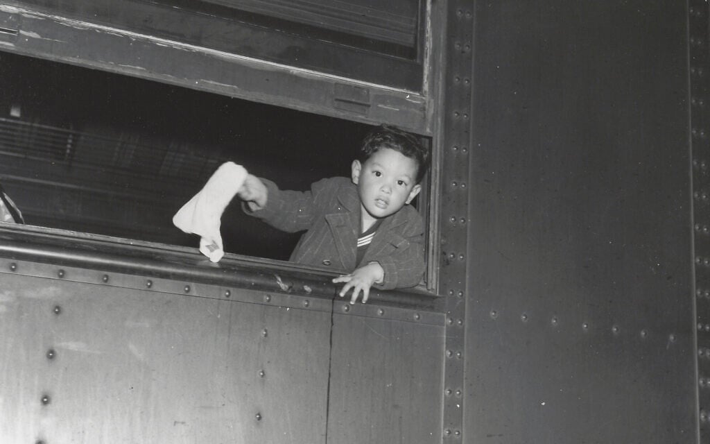 Tommy Yoneda on the train to Manzanar, waving goodbye. (Courtesy of Karl G. Yoneda Papers, UCLA Library Special Collections)