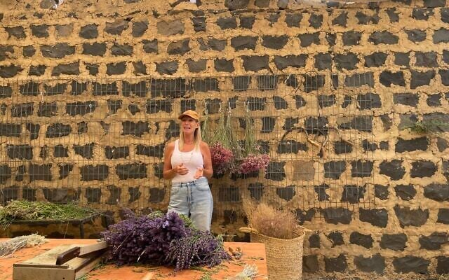 Lavender farmer Naomi Spellman Yehezkel in one of the workshop rooms of Sade Aromatics Farm in Kibbutz Ein Zivan in the Golan Heights on June 1, 2025 (Jessica Steinberg/Times of Israel)
