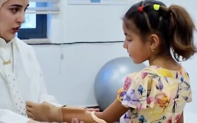 Screen capture from undated video of Sidra Al Bordeeni, 12, who was injured in the Gaza Strip, being fitted with a prosthetic arm in Amman, Jordan. (X: Used in accordance with Clause 27a of the Copyright Law)