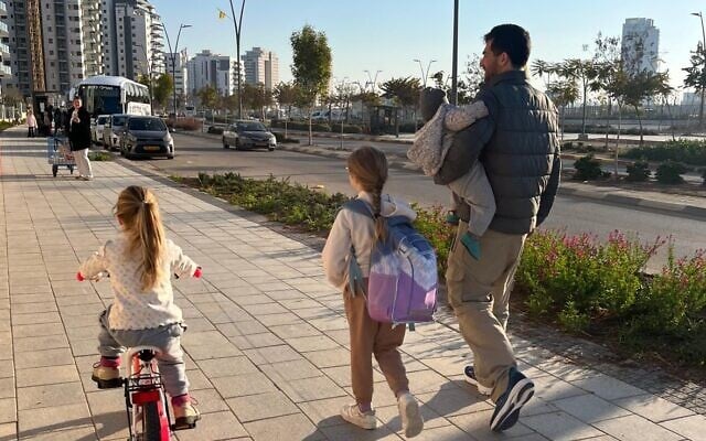 Former hostage Sagui Dekel-Chen with his three daughters, in their temporary hometown of Carmei Gat, after his February 2025 release from Hamas captivity (Courtesy)