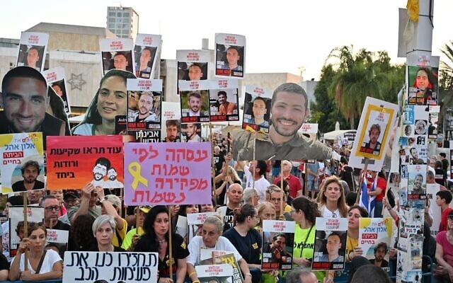 Pro-hostage deal protesters hoist pictures of Hamas hostages during a rally on Hostages Square in Tel Aviv, July 5, 2025. (Paulina Patimer/Pro-Democracy Protest Movement)