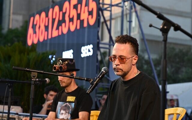 Gilad Kahana, left, of The Giraffes, performs on July 6, 2025, in Tel Aviv's Hostages Square, to mark the birthday of murdered hostage Guy Illouz. (Paulina Patimer/ Hostages and Missing Families Forum)