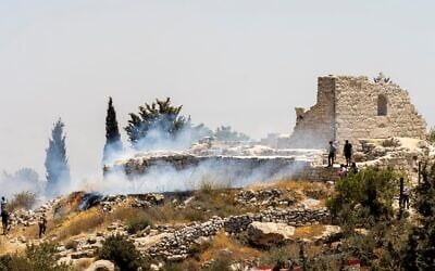 A fire burns next to the archaeological site of the ruins of the Church of St. George in the West Bank town of Taybeh, July 9, 2025. Residents allege that local settler extremists started the fire. (Courtesy Nabd ElHaya online radio station)