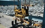 Caterpillar D9 bulldozers are unloaded from a ship at Haifa Port, July 9, 2025. (Defense Ministry)