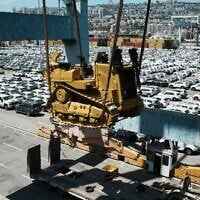 Caterpillar D9 bulldozers are unloaded from a ship at Haifa Port, July 9, 2025. (Defense Ministry)