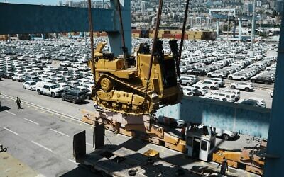 Caterpillar D9 bulldozers are unloaded from a ship at Haifa Port, July 9, 2025. (Defense Ministry)