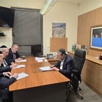 Members of the United Torah Judaism party's Degel Hatorah faction write letters of resignation in Knesset Finance Committee chairman Moshe Gafni's office. (Courtesy)
