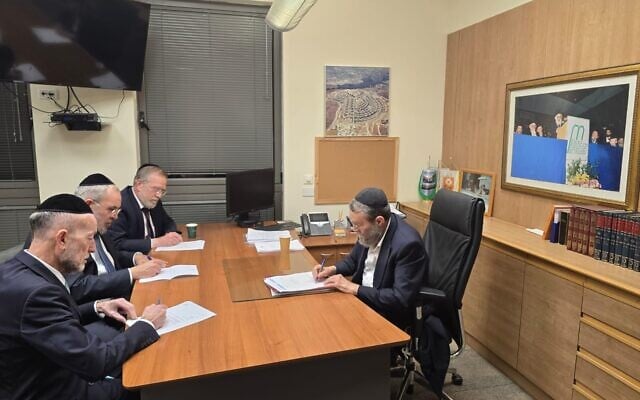 Members of the United Torah Judaism party's Degel Hatorah faction write letters of resignation in Knesset Finance Committee chairman Moshe Gafni's office. (Courtesy)