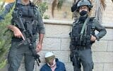 Border Police officers pose with Abed al-Karim Snober, a Palestinian terrorist accused of carrying out a botched bus bombing attack in February, following his arrest on July 22, 2025. (Israel Police)