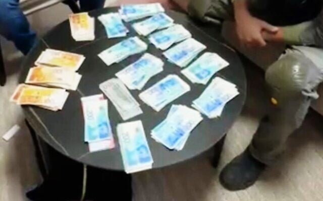 Banknotes seized by police while raiding the house of a Tamra resident suspected of funneling funds to the Palestinian Islamic Jihad, in a handout image published July 25, 2025. (Israel Police) Banknotes seized by police while raiding the house of a Tamra resident suspected of funneling funds to the Palestinian Islamic Jihad, in a handout image published July 25, 2025. (Israel Police)