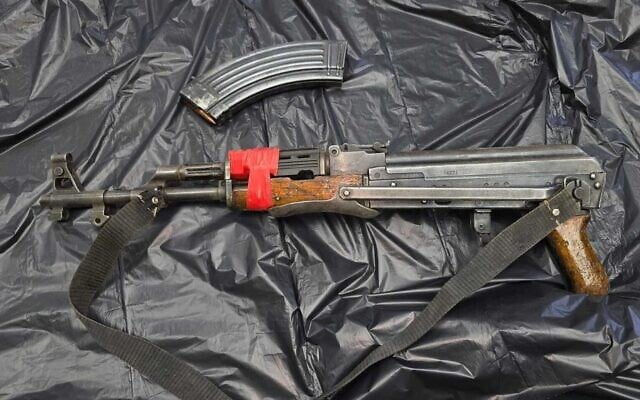 A Kalashnikov rifle and accompanying magazine seized by police from two Druze Israelis who, after crossing the border into Syria, tried to reenter Israel while armed on July 17, 2025. (Israel Police)