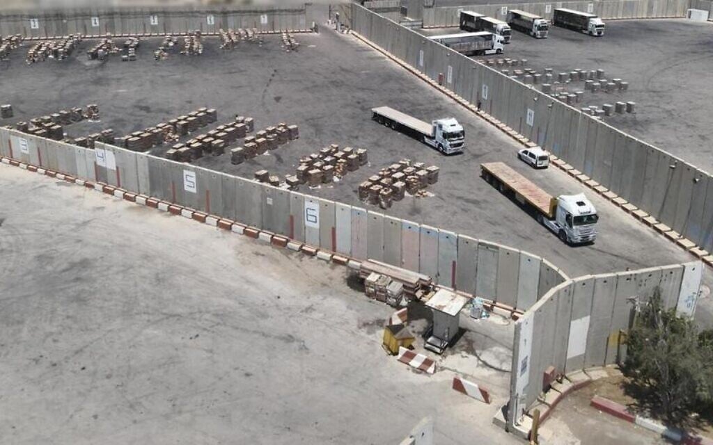 Trucks and aid boxes slated to be distributed in the Gaza Strip are seen in a photo published on July 28, 2025, by COGAT, the Defense Ministry agency that coordinates aid to Palestinian territories. (COGAT via X)