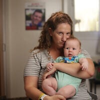Ela Haimi and her baby, Lotan, the youngest of her four children, born after her husband Tal Haimi was killed defending their kibbutz on October 7, 2023 and his body taken hostage to Gaza (David Janovic/IDFWO)